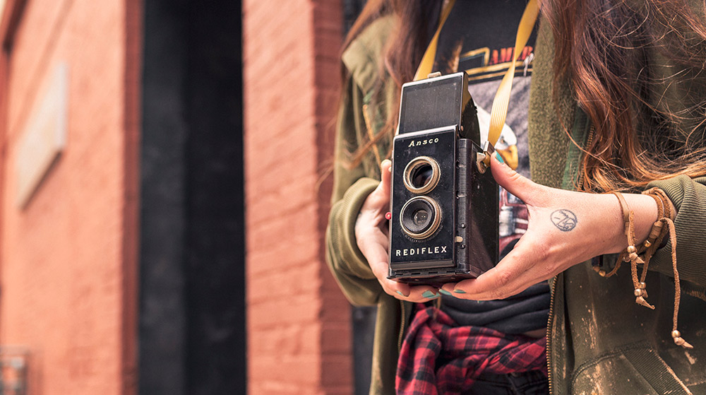 Girl holding an old camera